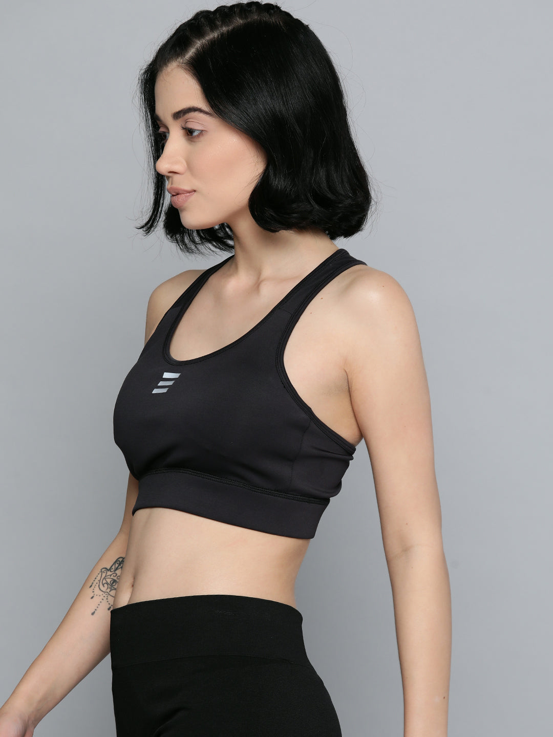 Alcis black grey workout bra for women with non-wired support and stretch polyester lycra fabric.