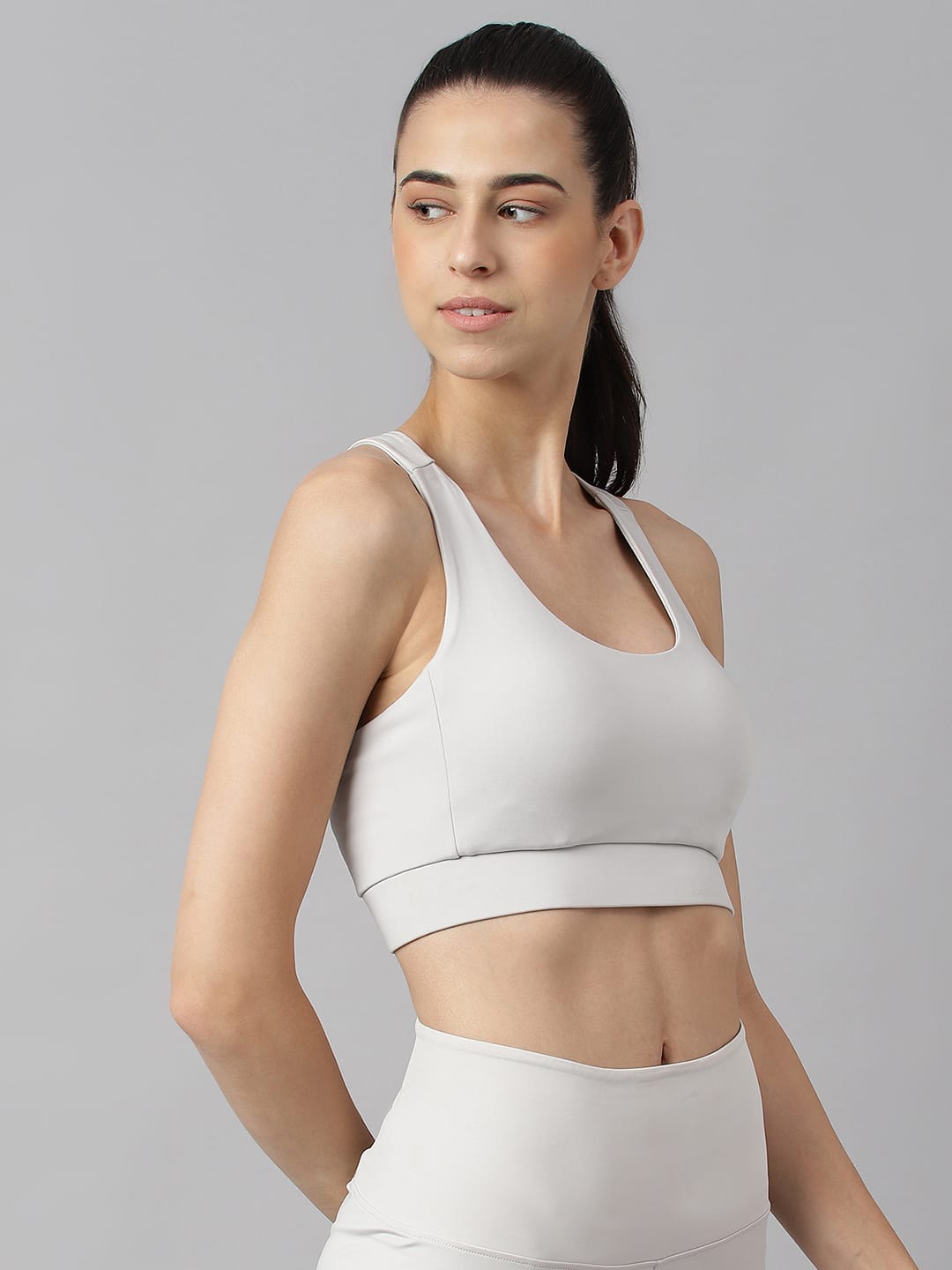 Alcis women light grey anti-static workout bra with slim fit design and moisture-wicking Drytech+ technology.