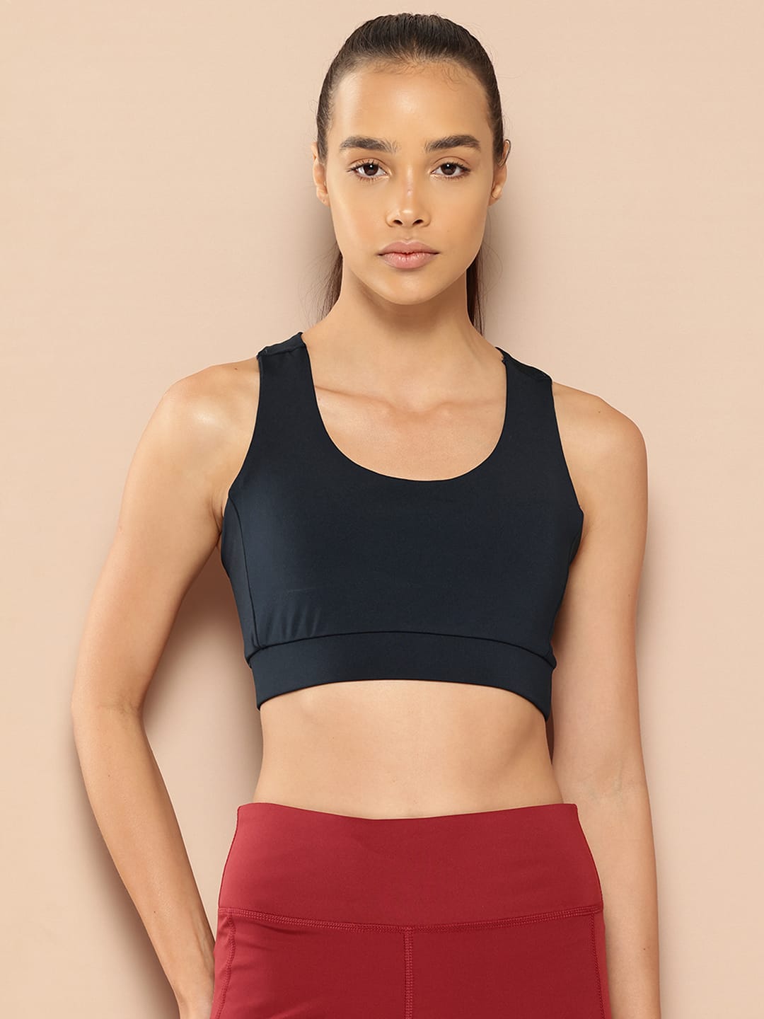 Alcis women navy low impact sports bra with Anti-Statix and Drytech+ technology for comfortable workouts.