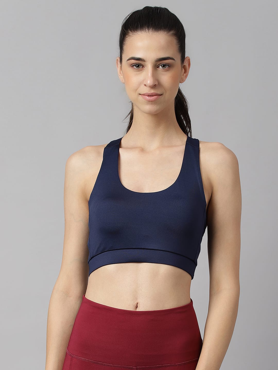 Alcis women navy slim fit low impact sports bra with flexible stretch fabric for gym, running and active wear.