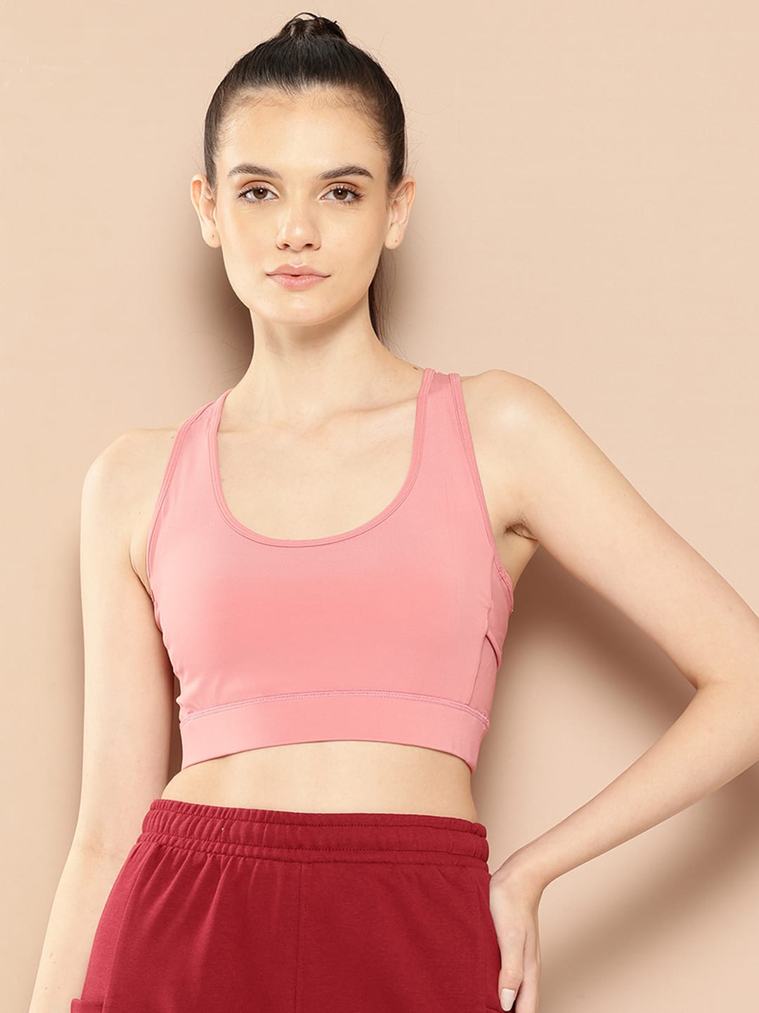 Alcis women pink solid full coverage workout bra with Drytech+ and Anti-Statix technology for gym training.