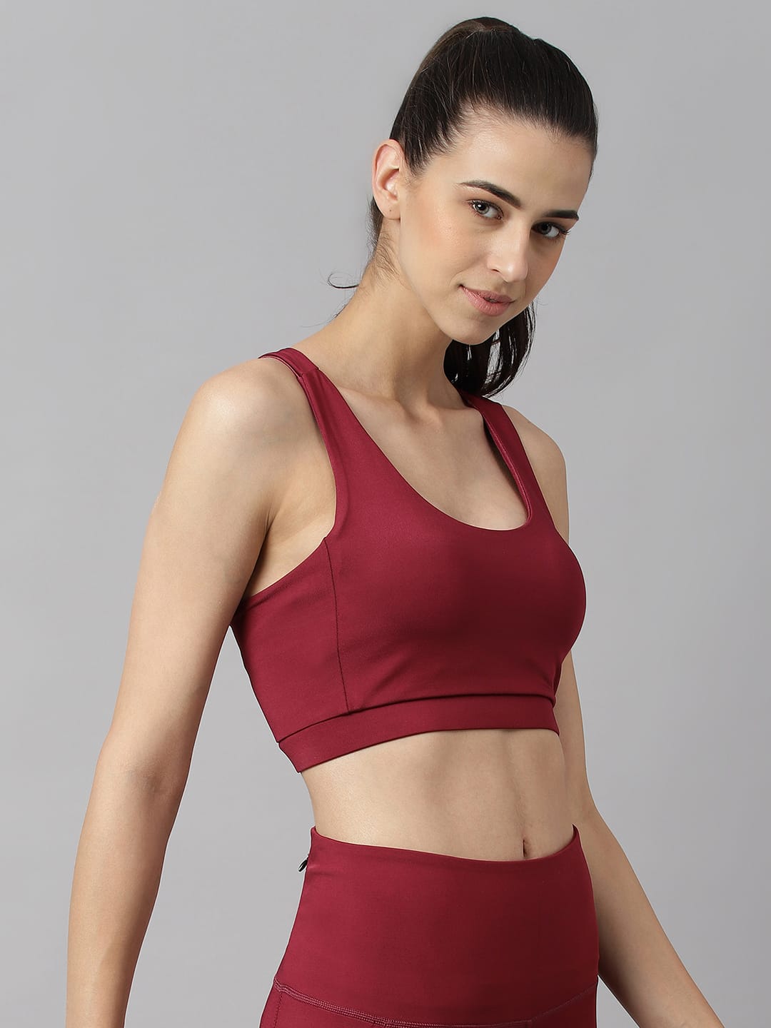 Alcis women red plum anti-static low impact sports bra with flexible stretch fabric for gym and active wear.