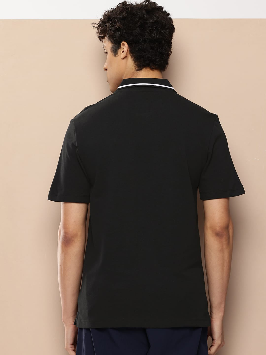 Men's black hidden zip polo by Alcis featuring a polo collar and soft cotton fabric for everyday comfort.