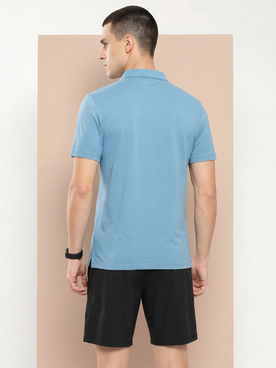 Men's blue zip polo T-shirt by Alcis featuring half sleeves and soft cotton blend fabric for everyday wear.
