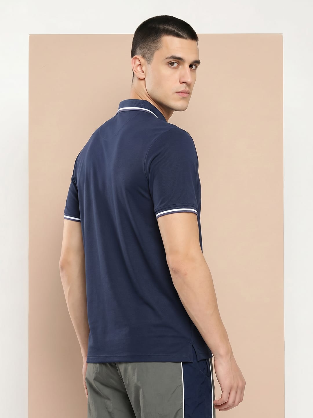 Men's navy performance polo by Alcis featuring lightweight quick-dry fabric for sports and training.