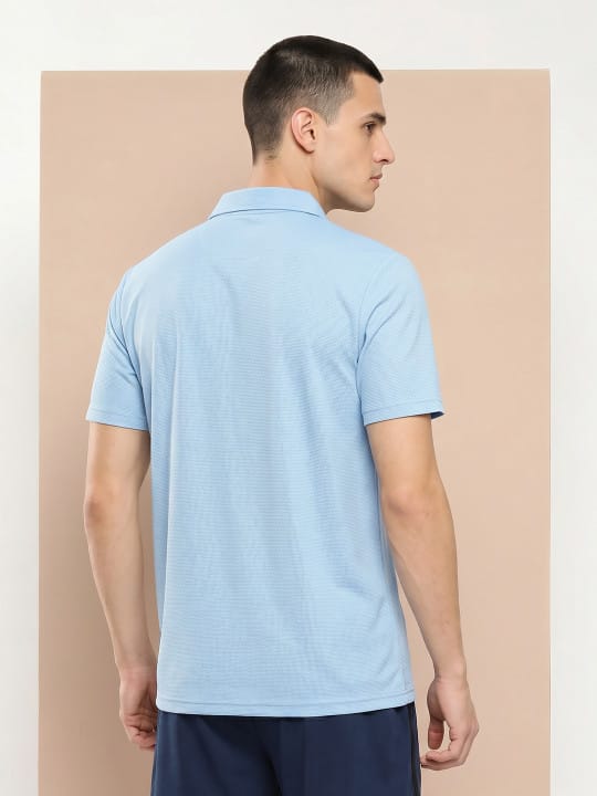 Men's sky blue Cloud Polo by Alcis featuring a minimal V-neck design for sports and casual wear.