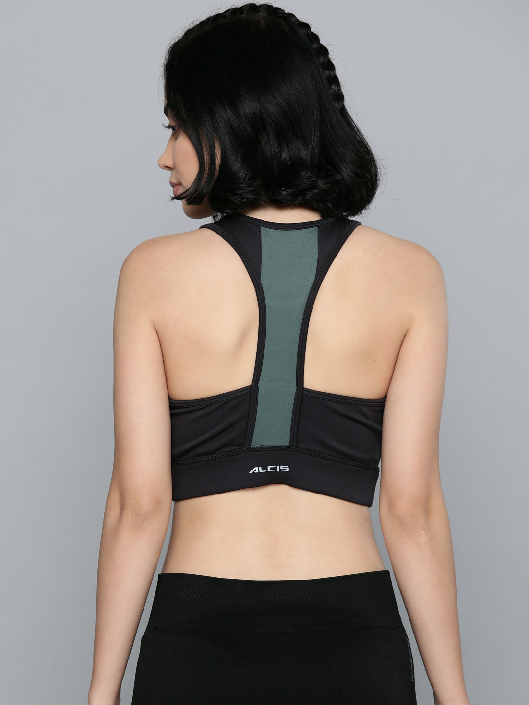 Women's black grey sports bra by Alcis featuring lightweight padding and breathable knitted fabric.