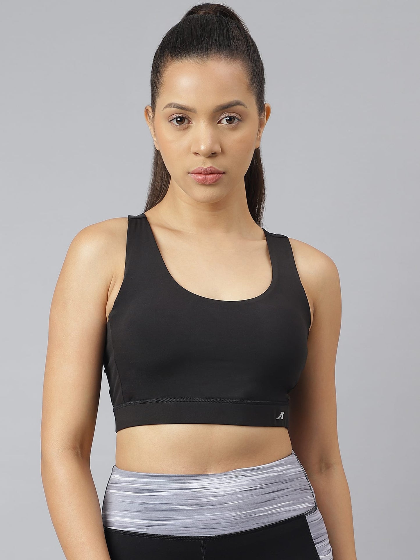 Women's black performance sports bra by Alcis with anti-static, moisture-wicking, and flexible stretch technology for training.