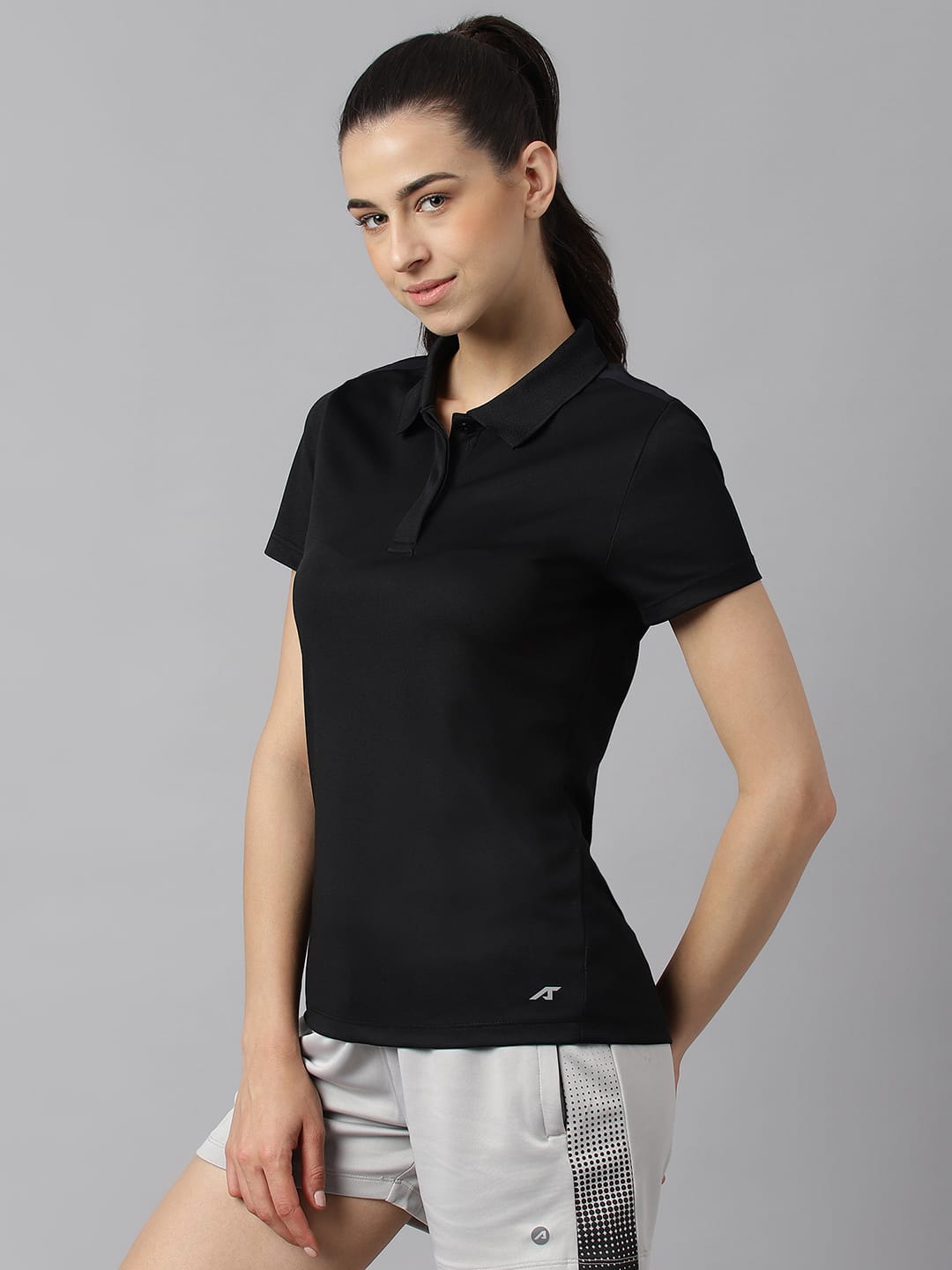 Women's black slim fit sports polo by Alcis with Airvent-X, Light-X fabric for gym, training and active wear.