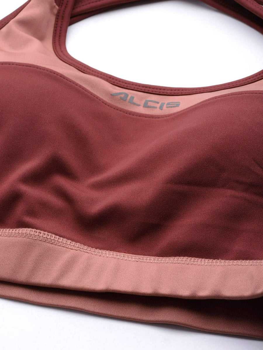 Women's burgundy and pink sports bra by Alcis with full coverage, lightly padded design and comfortable fit.