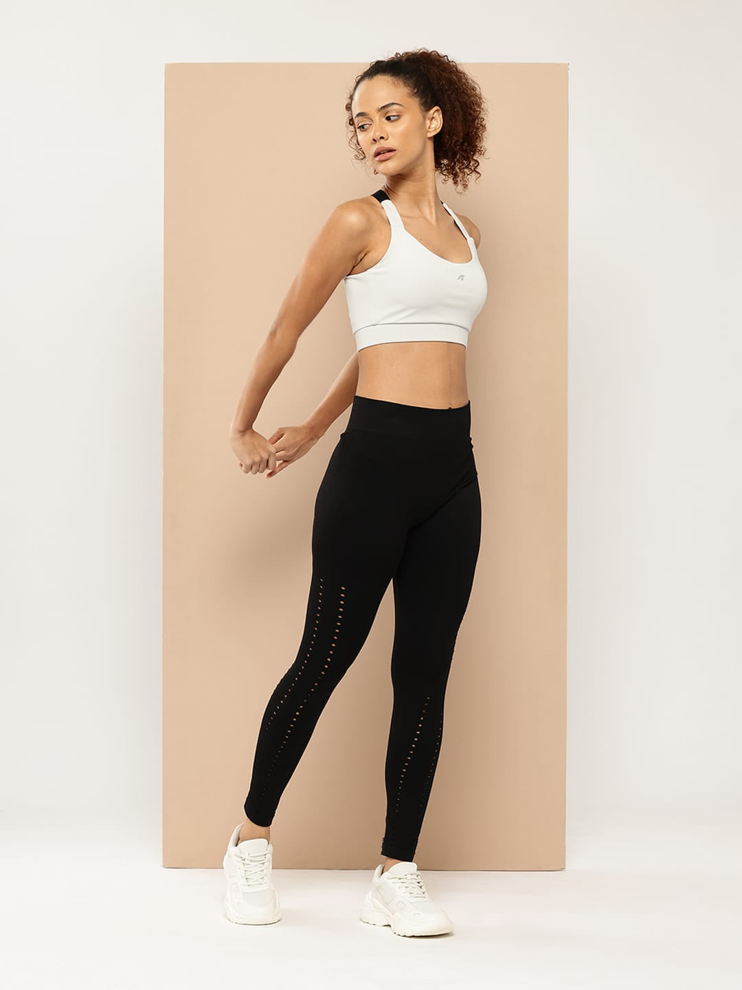 Women's light grey medium impact workout bra by Alcis with breathable polyester spandex stretch fabric.