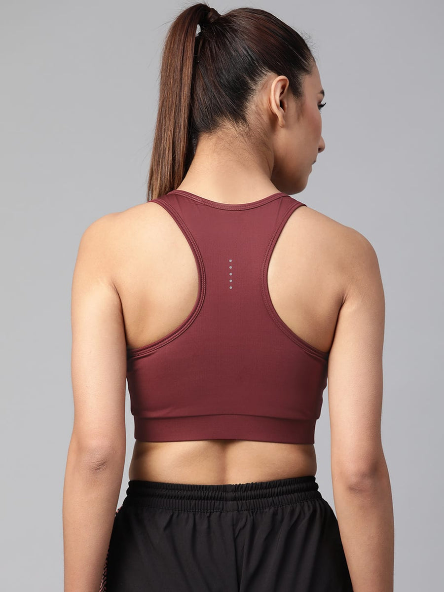 Women's maroon sports bra by Alcis featuring lightly padded cups and soft knitted fabric for workouts.