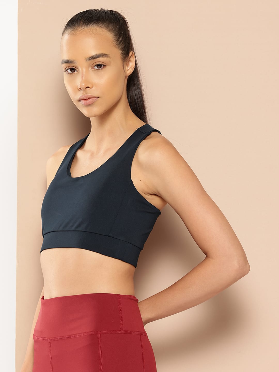 Women's navy slim fit sports bra by Alcis featuring Stretch-X fabric and Soft-Touch comfort for training.