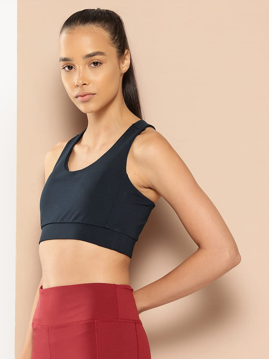 Women's navy slim fit sports bra by Alcis featuring Stretch-X fabric and Soft-Touch comfort for training.
