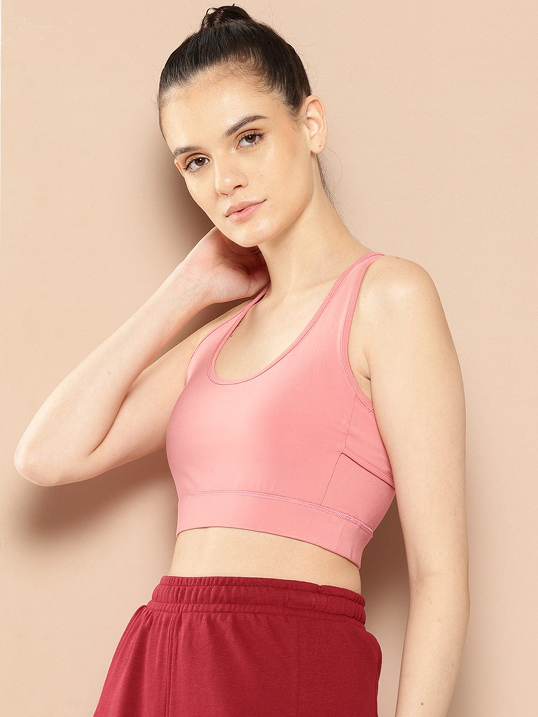 Women's pink full coverage sports bra by Alcis featuring Stretch-X fabric and Soft-Touch comfort.