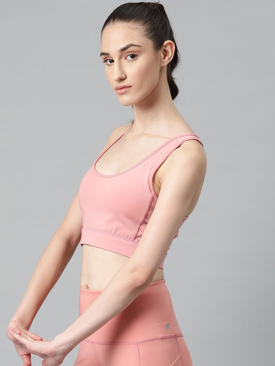 
                    
                      Women's pink slim fit sports bra with round neck and moisture-wicking fabric for gym, yoga and training by Alcis.
                    
                  