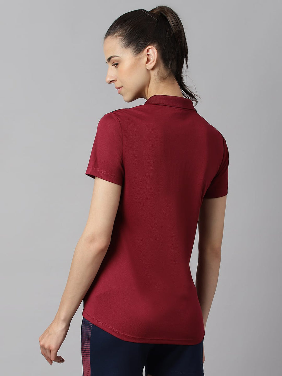 
                    
                      Women's red plum performance polo T-shirt with moisture-wicking technology for gym, training and active wear by Alcis.
                    
                  