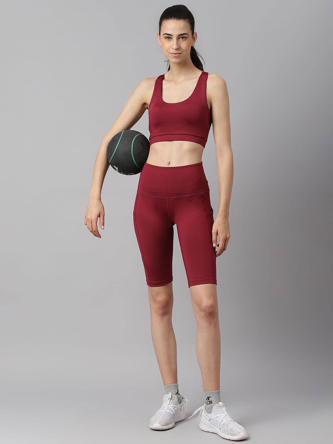 Women's red plum sleeveless sports bra with round neck and moisture-wicking performance fabric by Alcis.