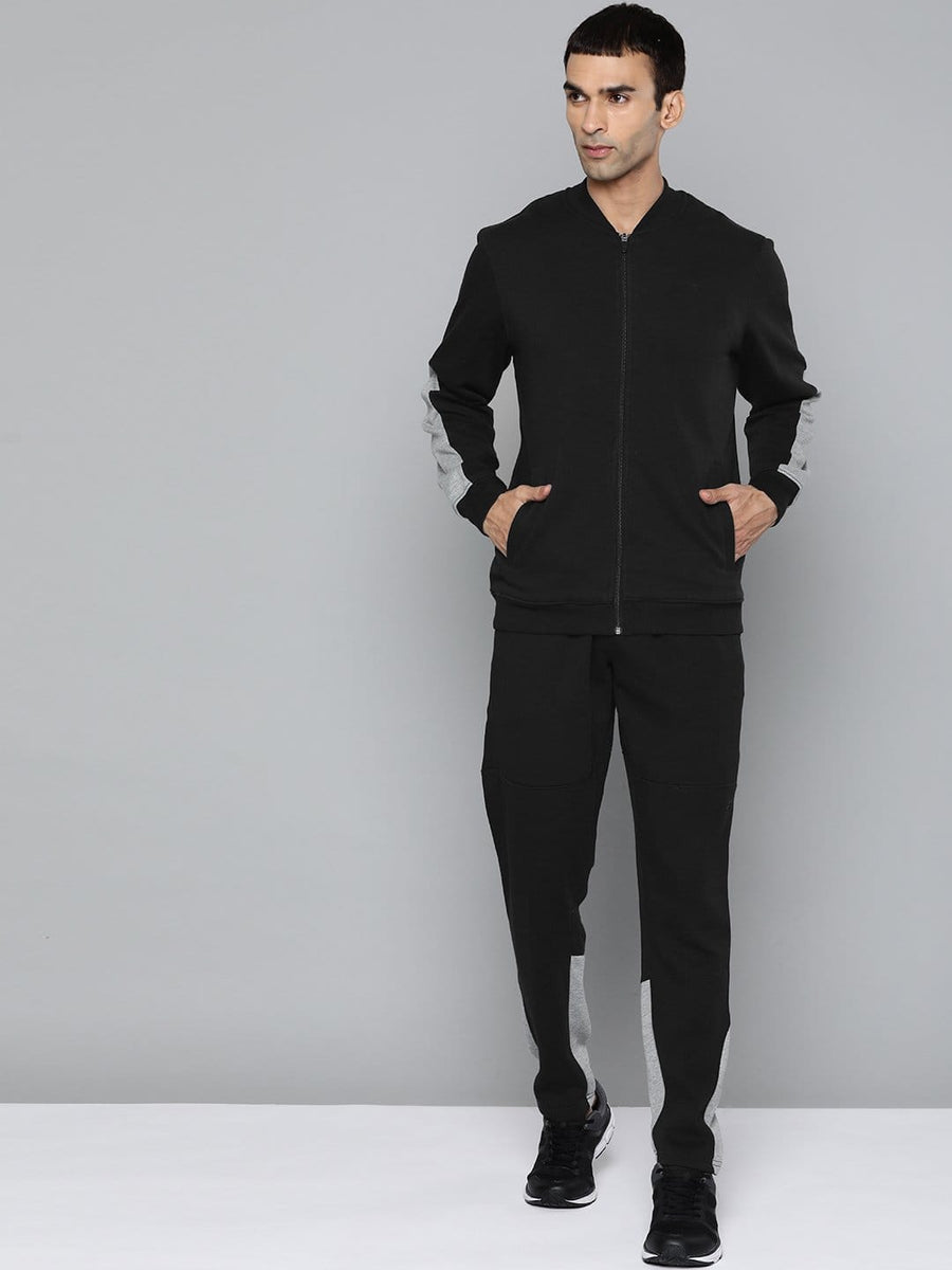 Alcis men solid black tracksuit with zip-up jacket and mid-rise track pants for sports, training and casual wear.
