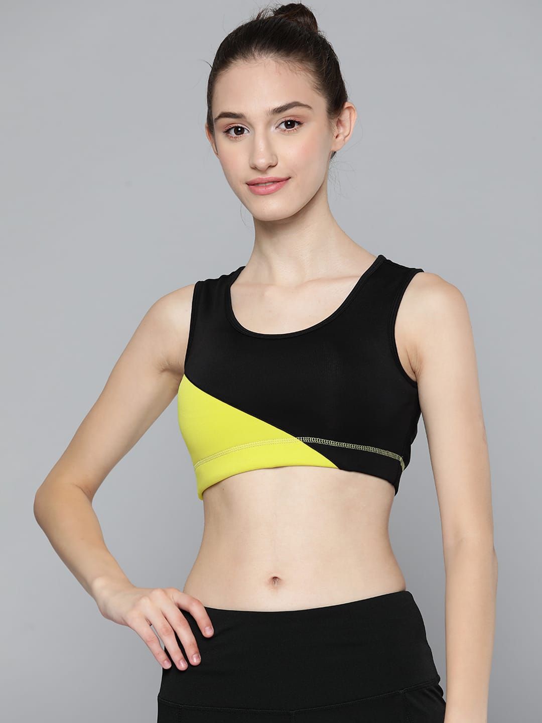 Alcis women black and yellow colourblocked lightly padded bra with comfortable sleeveless design.