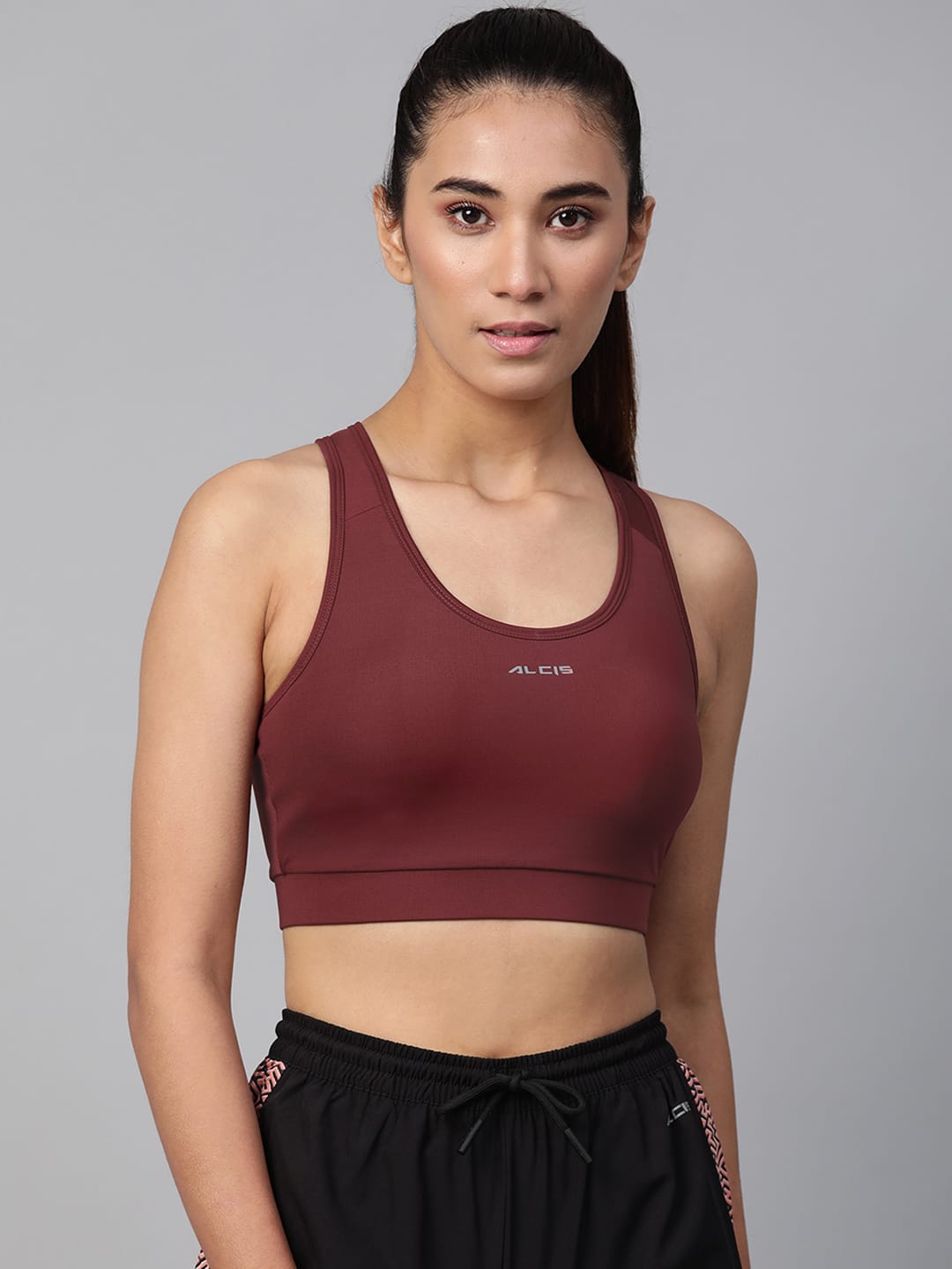 Alcis women maroon solid non-wired lightly padded workout bra with comfortable stretch fabric.