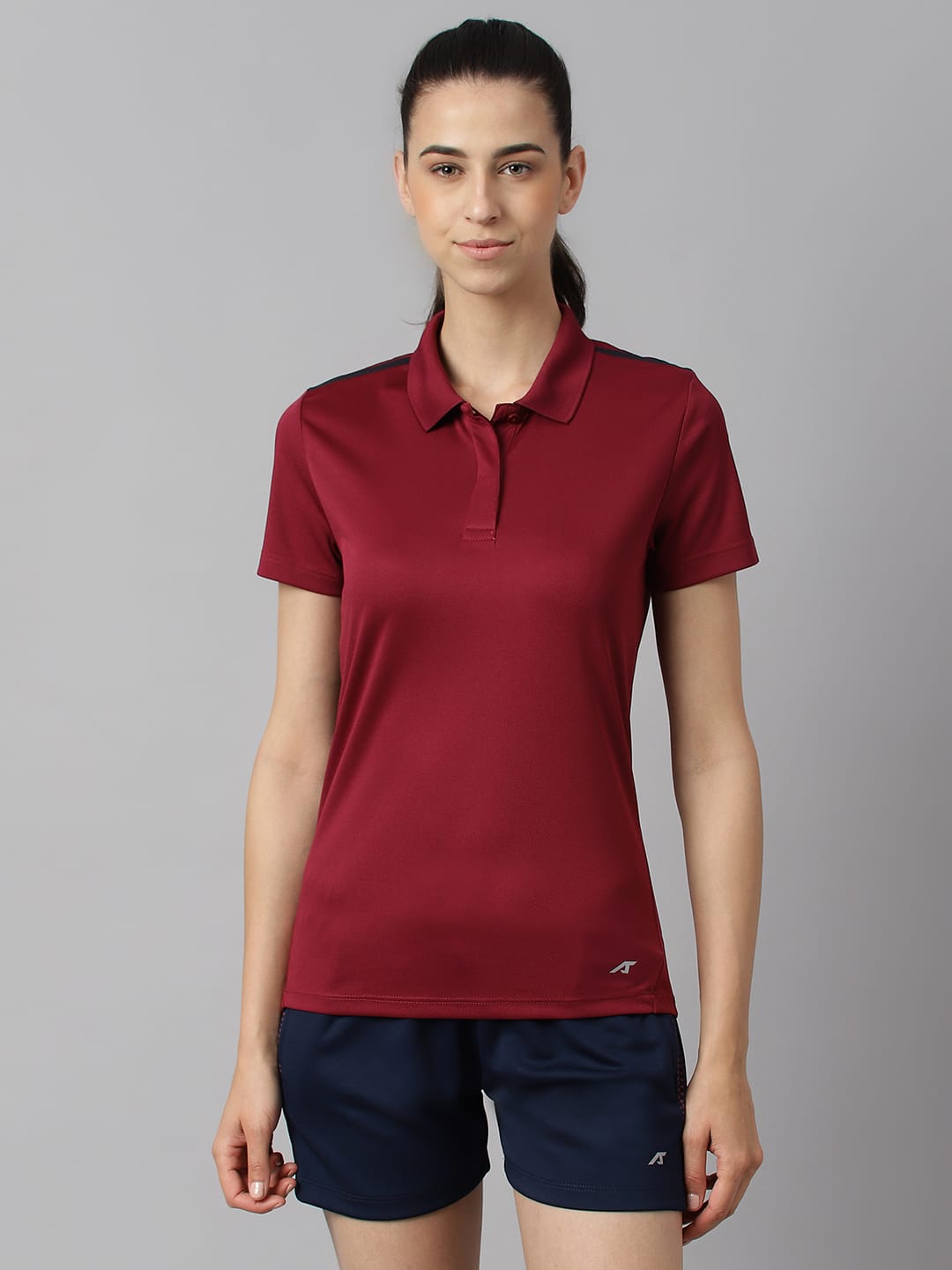 Alcis women red plum Wonder training polo T-shirt with Anti-Statix and Drytech+ technology.